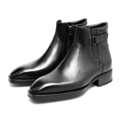 Black leather boots with a buckle on a white background